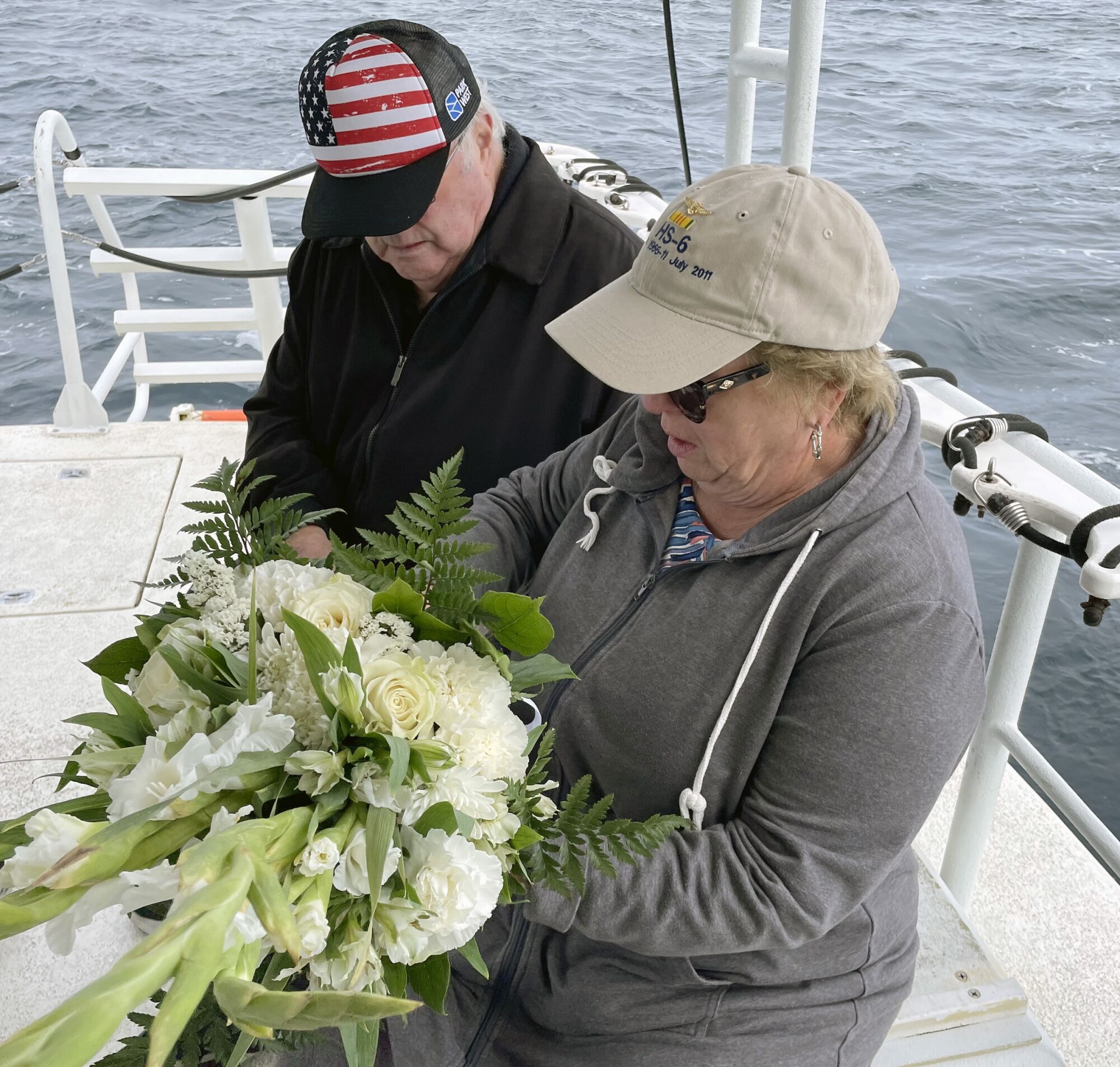 Peter and Janet Dunne hold flowers for the memorial service. 
