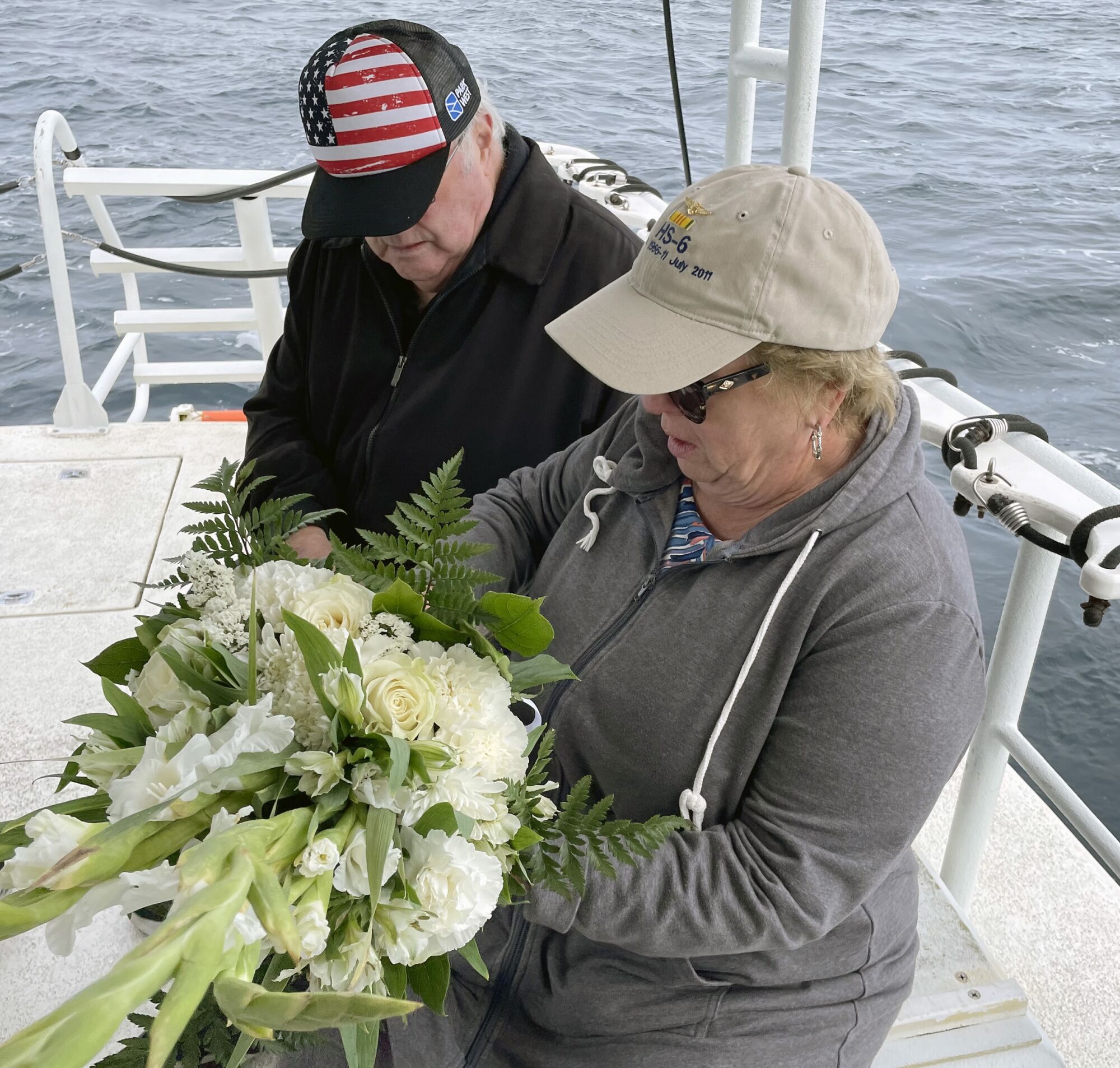 Peter and Janet Dunne hold flowers for the memorial service.