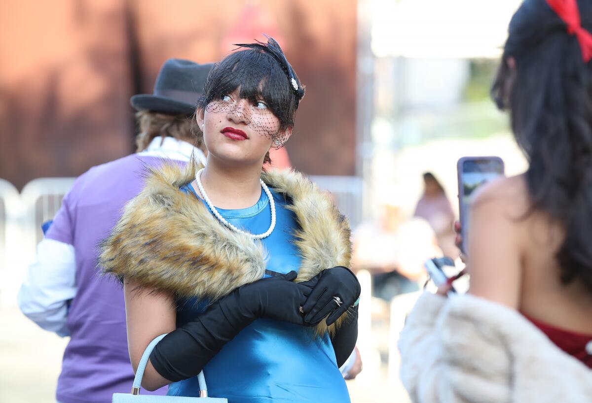 A woman dressed as Mrs. Peacock.