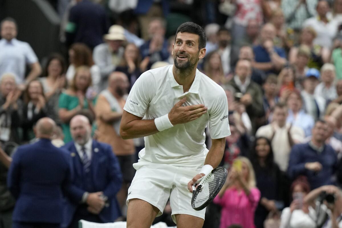 Novak Djokovic reacts after beating Italy's Jannik Sinner in a Wimbledon men's singles semifinal match Friday.
