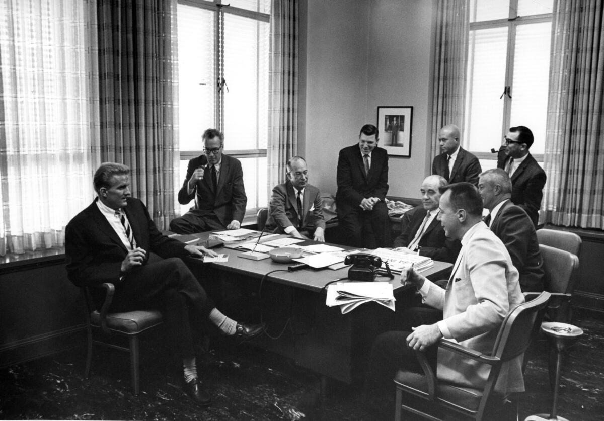 Publisher Otis Chandler, left, meets with The Times editorial board in the 1960s. Chandler, who left the paper's conservative political legacy behind, often found himself at odds with members of his family as a result.