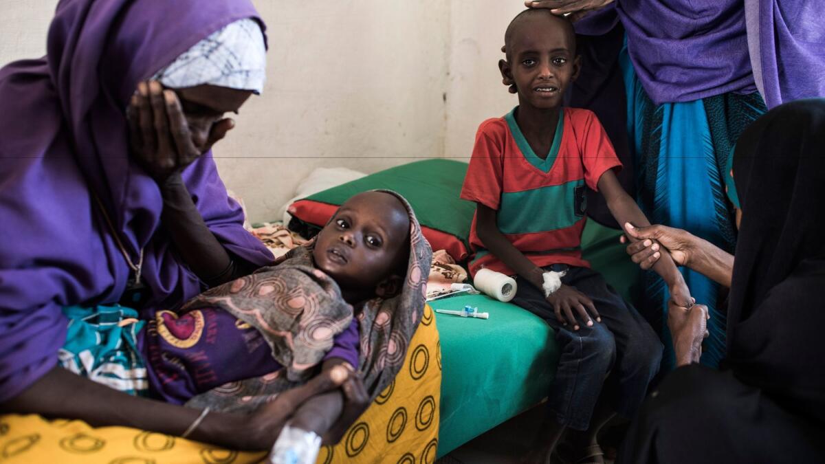 Somali mothers seek treatment for malnourished children. Drought is threatening millions across the country, the United Nations says.