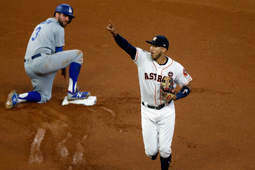 Astros shortstop Carlos Correa celebrates after after tagging out Dodger Chris Taylor