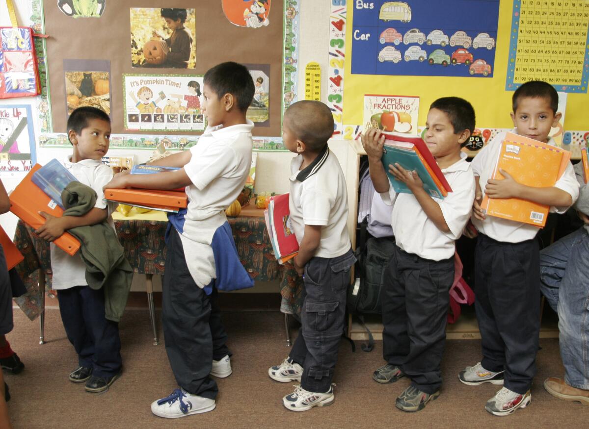 Second-graders at Oasis Elementary School in Twentynine Palms line up with language arts books. A letter from authors to President Obama says: "Our public school students spend far too much time preparing for reading tests and too little time curling up with books that fire their imaginations."