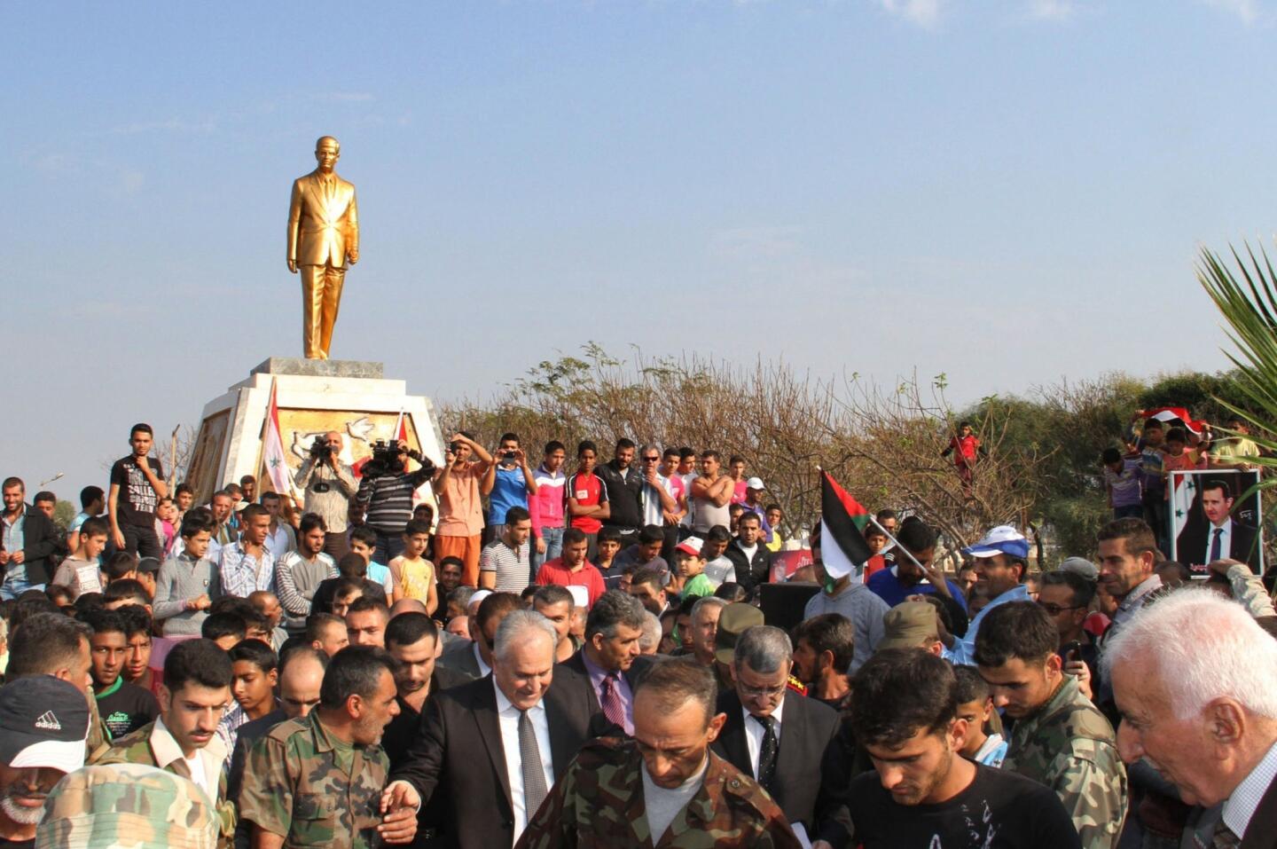 Syria scored 17 points and tied with two other countries. The country is embroiled in a bitter civil war that started in 2011. Above, crowds attend the unveiling of a statue of former Syrian President Hafez al-Assad last month in the coastal city of Tartous.