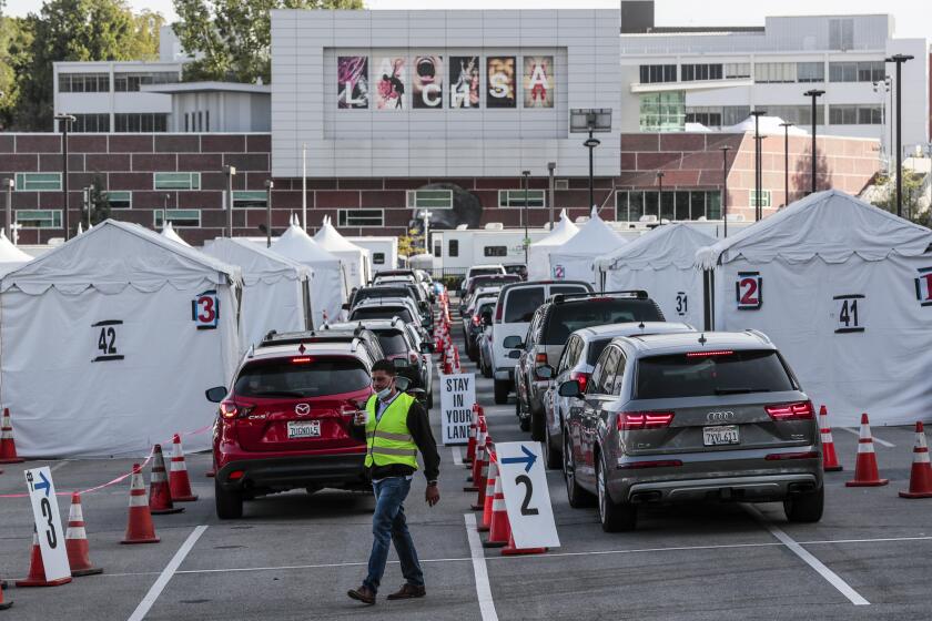 Los Angeles CA, Monday, April 5, 2021 - Drivers line up for Covid-19 vaccines at Cal State LA the day it is announced that 4 million shots have been provided to under served communities. (Robert Gauthier/Los Angeles Times)