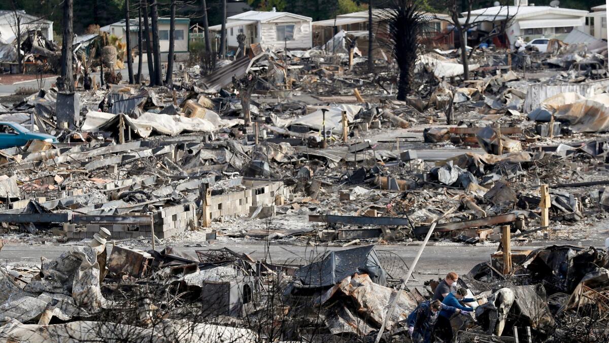 Police in Santa Rosa, Calif., arrested two suspects after a high-speed chase through city streets along the southern edge of destruction where the Tubbs Fire had burned. Residents, above, clear away debris from neighborhood damaged by the firestorm.