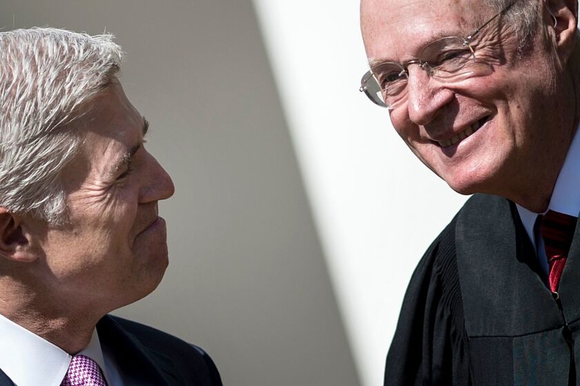 (FILES) In this file photo taken on April 10, 2017 Neil Gorsuch (L) smiles at Supreme Court Justice Anthony Kennedy before taking the judicial oath during a ceremony in the Rose Garden of the White House in Washington, DC. US media said on June 27, 2018 that Supreme Court Justice Kennedy will retire, effective on July 31, 2018. / AFP PHOTO / Brendan SmialowskiBRENDAN SMIALOWSKI/AFP/Getty Images ** OUTS - ELSENT, FPG, CM - OUTS * NM, PH, VA if sourced by CT, LA or MoD **