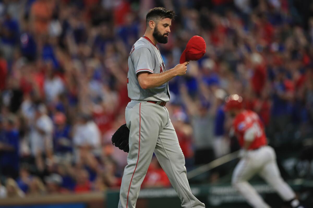 Angels starting pitcher Matt Shoemaker reacts after giving up a three-run homer to Mitch Moreland of the Texas Rangers in the third inning.