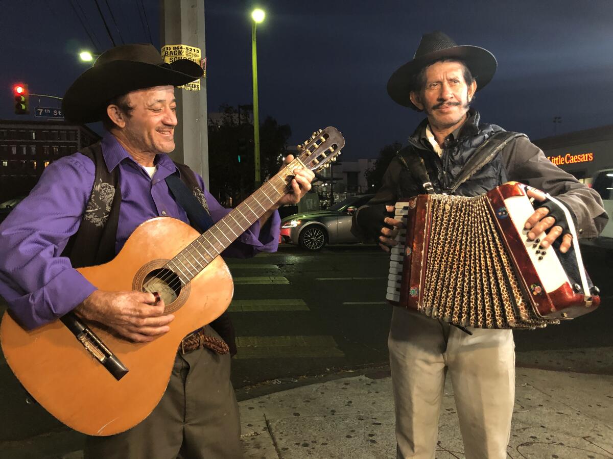 Elías Flores and César Villanueva perform at the corner of Union and 7th Street.