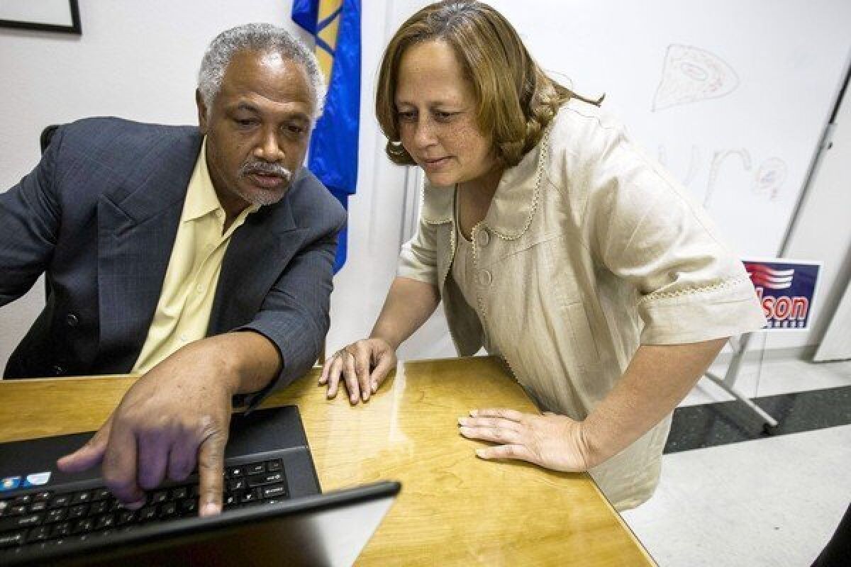 Rep. Laura Richardson, right, and a campaign volunteer review incoming results during the June primary. Despite her House reprimand for misusing government resources by illegally requiring her congressional staff to do campaign work, some election watchers refuse to count her out of the fall race.