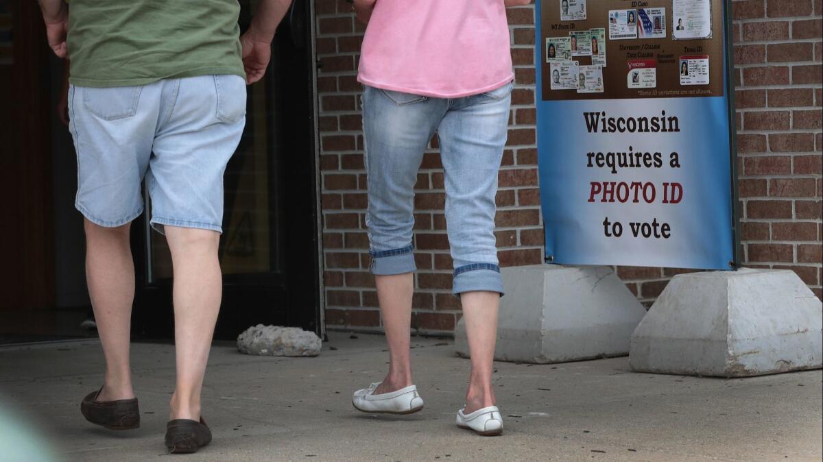 A sign reminding Wisconsin voters that ID is required for the Aug. 14, 2018, primary.