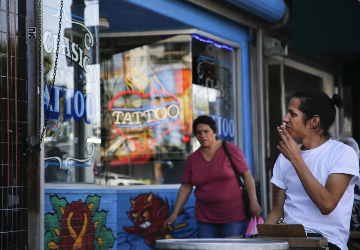 A shopper enjoys a cigarette along Sunset Boulevard in Echo Park.