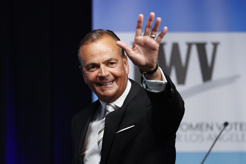 Rick Caruso waves at the start of last week's mayoral debate at Cal State Los Angeles.