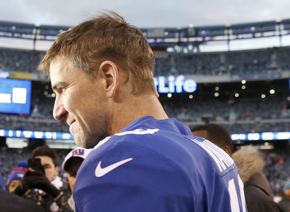 Eli Manning talks to reporters after a game against the Miami Dolphins on Sunday at MetLife Stadium.