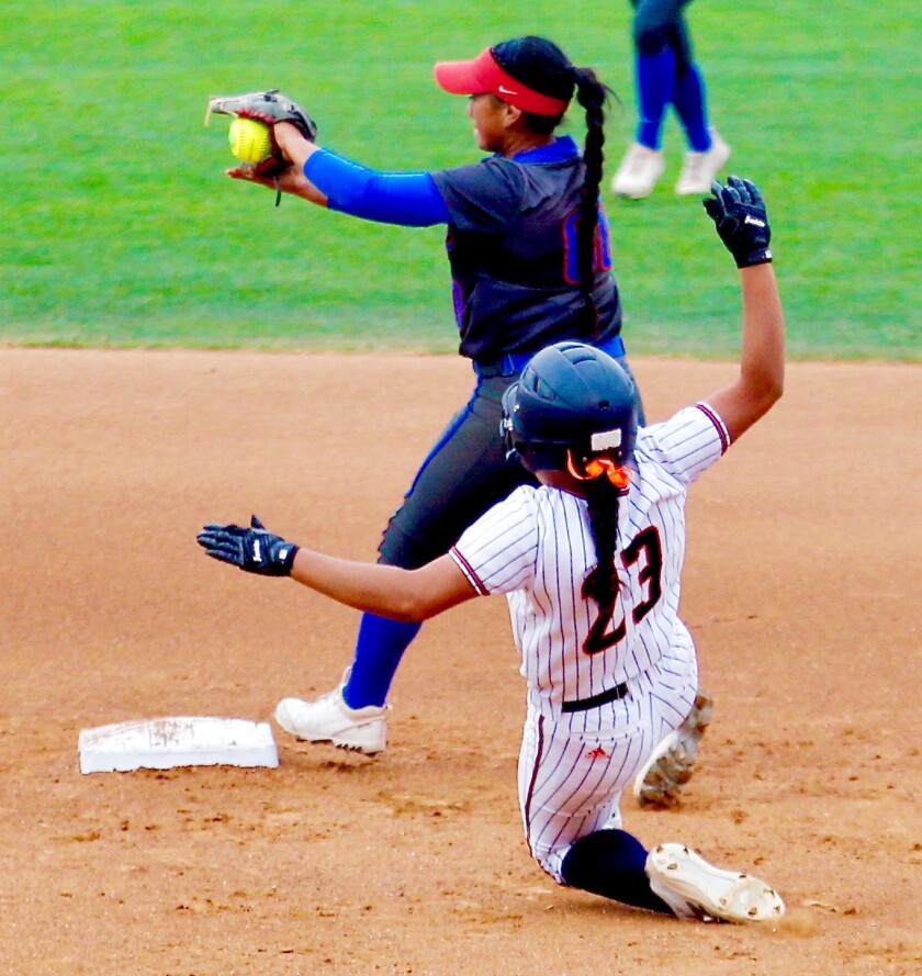 Los Alamitos second baseman Jordan Elias steps on the bag ahead of the slide by Eastvale Roosevelt baserunner Jazzy Santos.