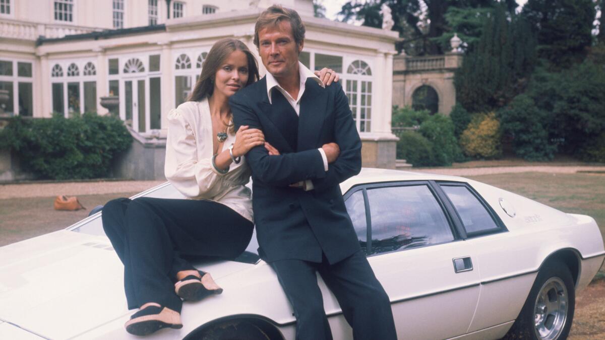 Barbara Bach and Roger Moore, stars of the James Bond movie "The Spy Who Loved Me," leaning on the now–famous Lotus Esprit.