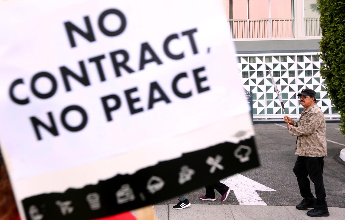 Jacinto Antonio Herrera, with a sign that says "No contract no peace"
