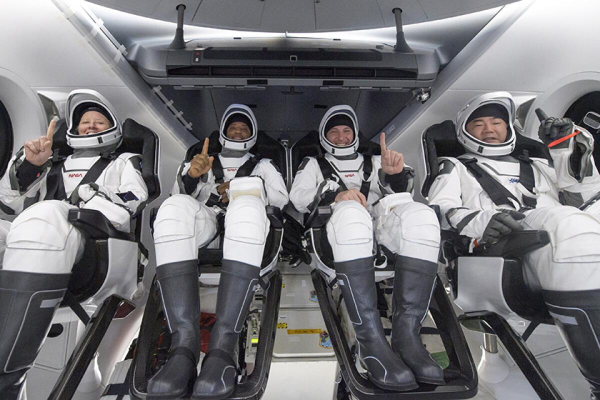 Astronauts Shannon Walker, Victor Glover, Mike Hopkins and Soichi Noguchi inside SpaceX's capsule early Sunday.