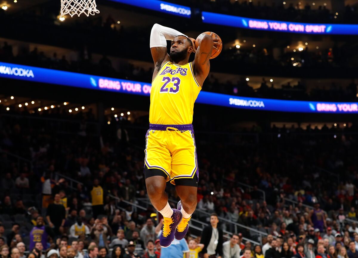 Lakers star LeBron James dunks during the first half of a 101-96 victory over the Atlanta Hawks on Sunday.