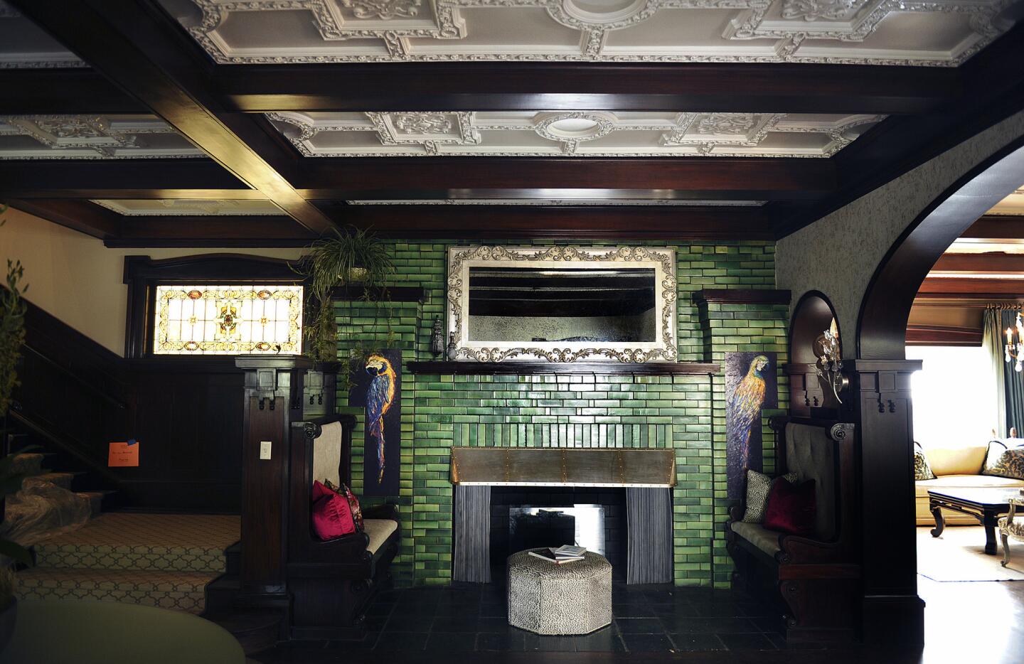 Visitors to the latest Pasadena Showcase House of Design will be greeted by a historic fireplace framed by emerald green Grueby tile, which is original to the house.