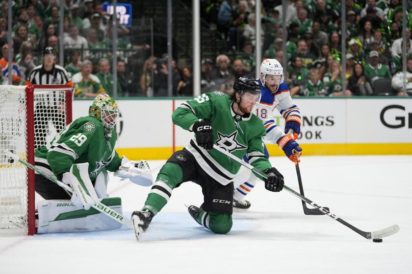 Dallas Stars defenseman Thomas Harley (55), blocks as shot as goaltender Jake Oettinger (29) and Edmonton Oilers left wing Zach Hyman (18) look on during the second period of Game 5 of the Western Conference finals in the NHL hockey Stanley Cup playoffs Friday, May 31, 2024, in Dallas. (AP Photo/Julio Cortez)