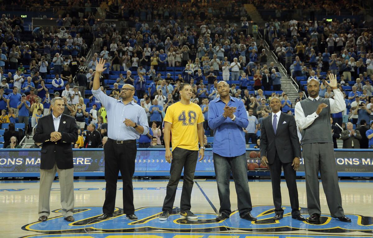 Members of the 1995 UCLA NCAA championship team — coach Jim Harrick, left, Kris Johnson, Toby Bailey, Charles O'Bannon, Tyus Edney and Ed O'Bannon — appear at halftime during a 2015 game at Pauley Pavilion.