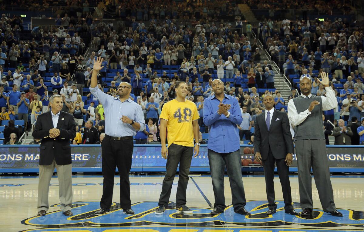 Members of the 1995 UCLA NCAA championship team — coach Jim Harrick, left, Kris Johnson, Toby Bailey, Charles O'Bannon, Tyus Edney and Ed O'Bannon — are honored at during halftime of a game at Pauley Pavilion in 2015.