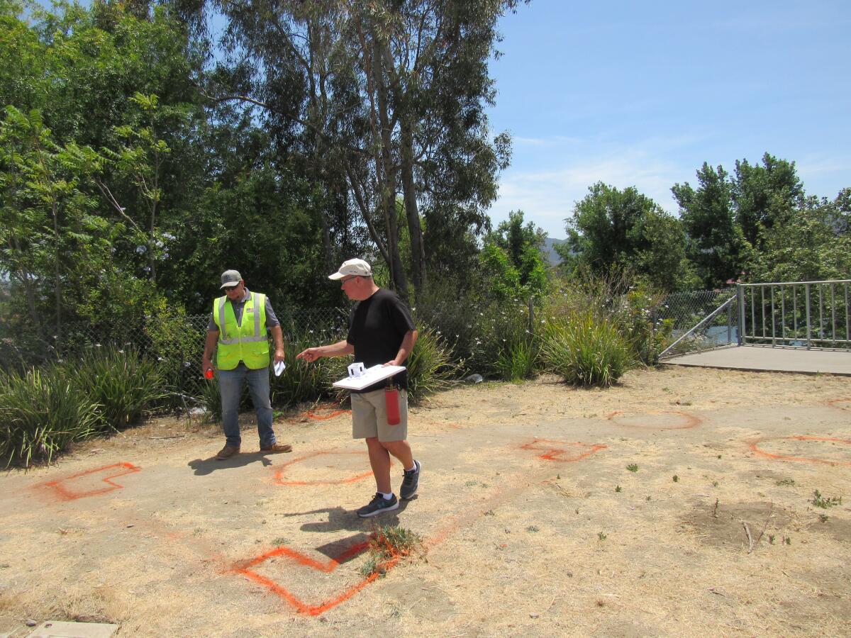 Santee City Councilman Dustin Trotter (left) and designer Michael Ranson assess where a veterans monument will be.