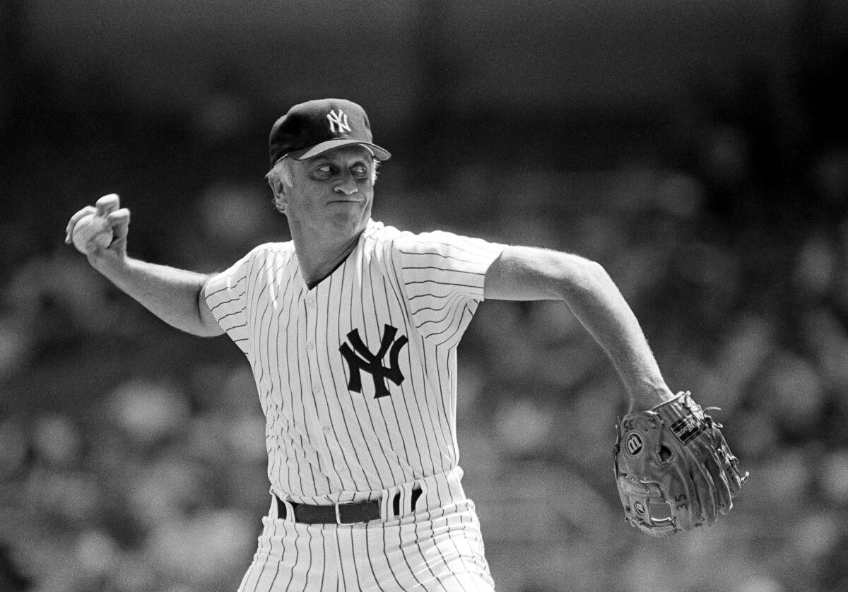 New York Yankees 45-year-old starter Phil Niekro throws a knuckleball against the Chicago White Sox.