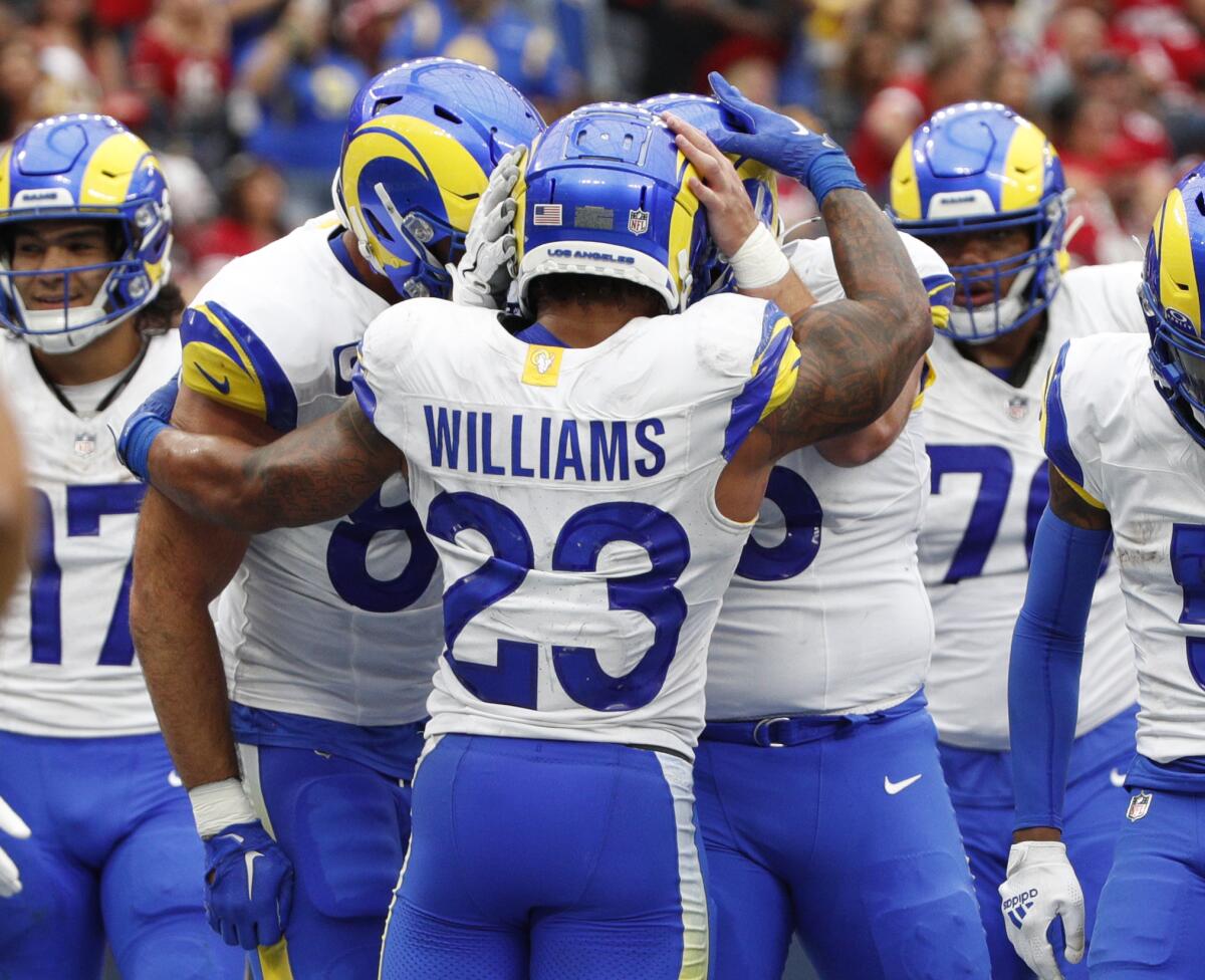 Rams running back Kyren Williams (23) celebrates his first half touchdown against San Francisco with teammates.