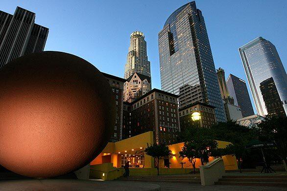 Pershing Square shines in an evening tableau. The city is about to take the scalpel again to the repeatedly renovated square -- this time, to better serve the residential population that has moved to downtown Los Angeles. Plans call for more grass, less concrete and perhaps space for residents' dogs to run.