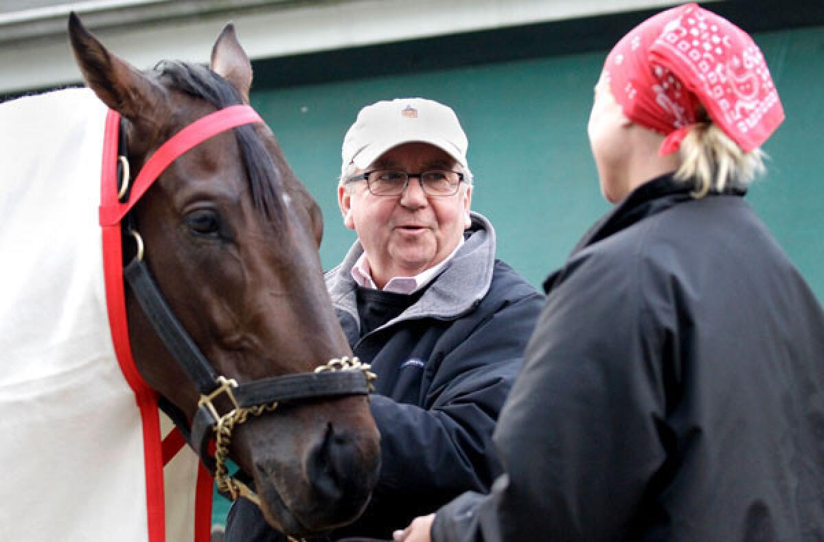 Trainer Shug McGaughey talks to exercise rider Jennifer Patterson after she took Orb through his paces Wednesday at Pimlico Race Course.