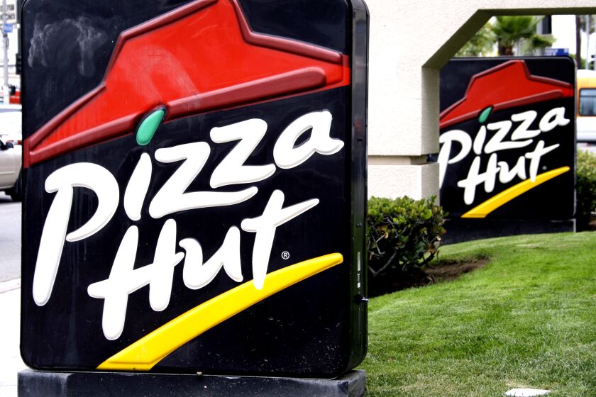 Signs in front of a Pizza Hut restaurant is seen in Los Angeles.