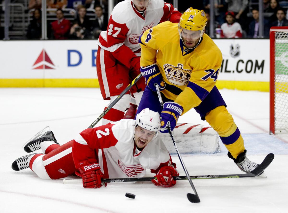 Kings defenseman Dwight King knocks Red Wings defenseman Brendan Smith to the ice during the second period of a game Tuesday at Staples Center. The Kings' victory over Detroit, 1-0.