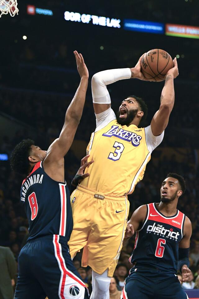 Lakers forward Anthony Davis puts up a shot over Wizards forward Rui Hachimura during the first half of a game Nov. 29 at Staples Center.