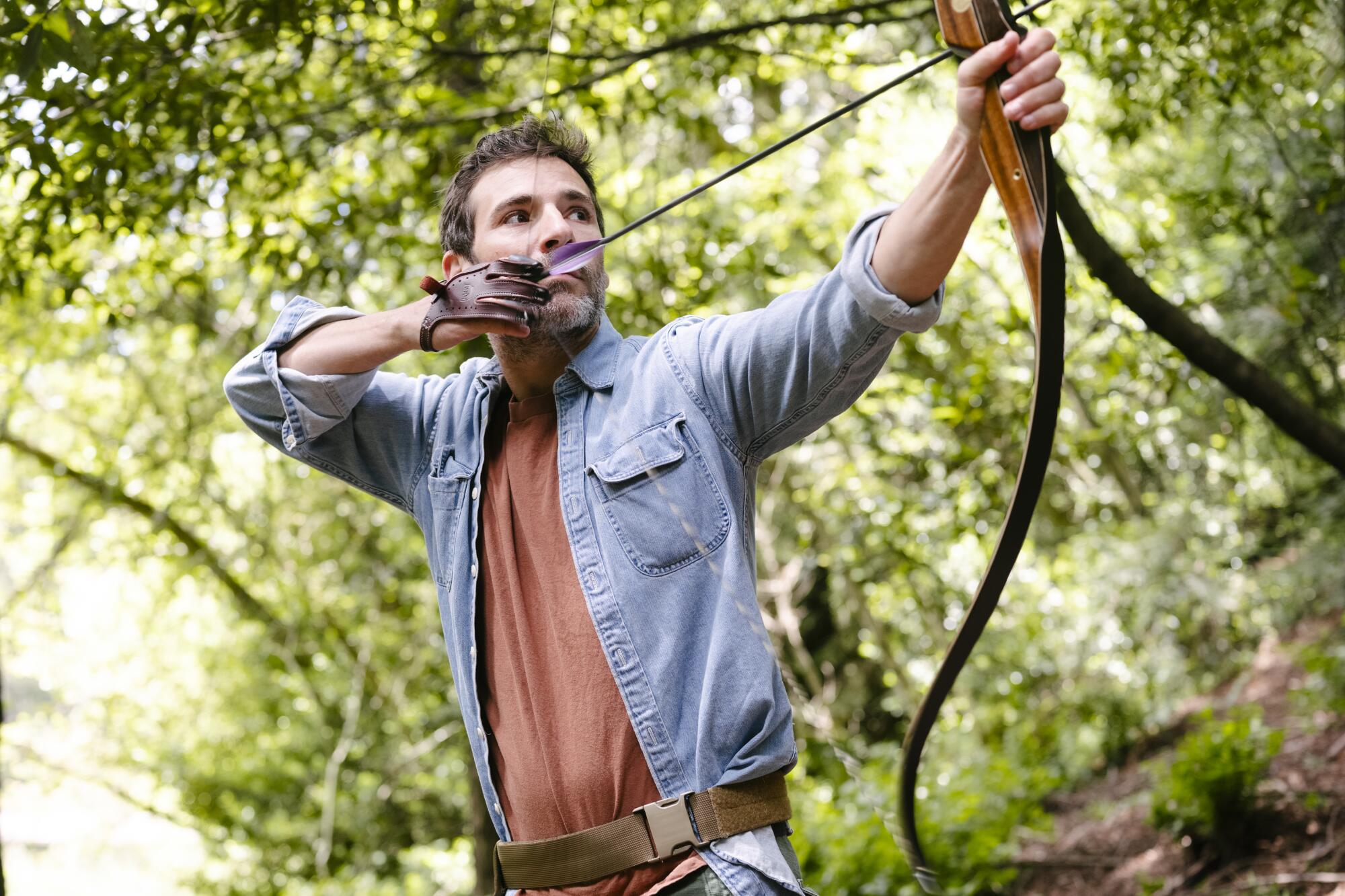 Jeff Bercovici takes aim at the Redwood Bowmen archery range in Oakland.