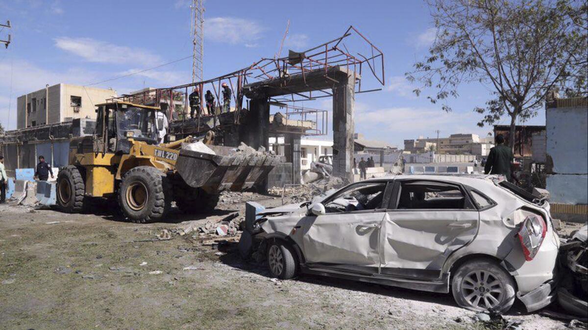 The wreckage of a car is seen after a suicide bombing at the gate of a police headquarters in the southeastern Iranian port city of Chabahar on Dec. 6.