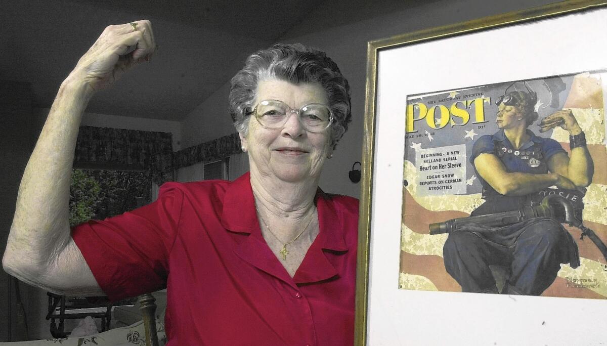 Mary Doyle Keefe in 2002 with the cover of the May 29, 1943, cover of the Saturday Morning Post. Twenty-four years after she posed for it, Norman Rockwell sent Keefe a letter apologizing for the hefty body in the painting.