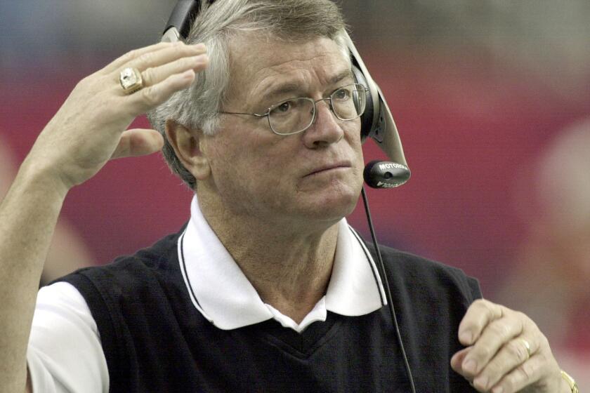 FILE - Atlanta Falcons coach Dan Reeves adjusts his headset at the start of play against the Detroit Lions at the Georgia Dome in Atlanta Sunday, Dec. 22, 2002. Reeves, who won a Super Bowl as a player with the Dallas Cowboys but was best known for a long coaching career highlighted by four more appearances in the title game with the Denver Broncos and Atlanta Falcons, died Saturday, Jan. 1, 2022. (AP Photo/Ric Feld, File)