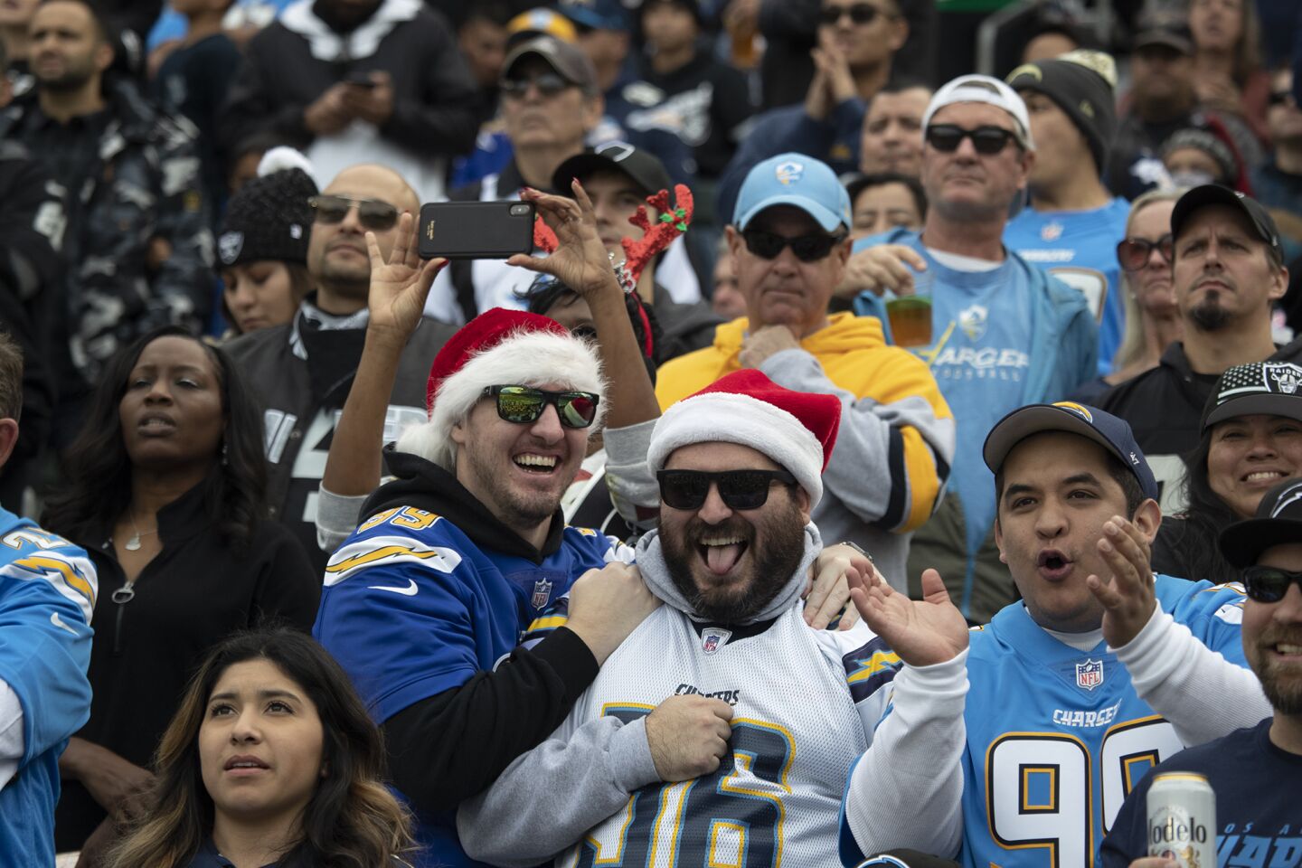 Chargers fans celebrate after a play against the Oakland Raiders.