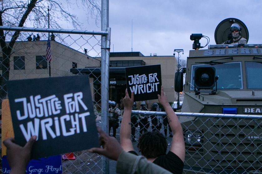 BROOKLYN CENTER, MN - APRIL 14: Protesters gather outside the Brooklyn Center Police Department calling for justice for Daunte Wrighton Wednesday, April 14, 2021 in Brooklyn Center, MN. (Jason Armond / Los Angeles Times)