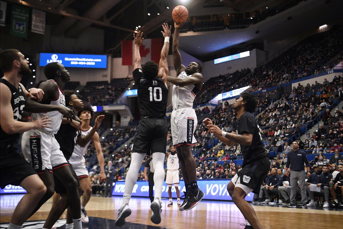 Connecticut's Adama Sanogo shoots as Butler's Bryce Nze (10) defends during the first half of an NCAA college basketball game Tuesday, Jan. 18, 2022, in Hartford, Conn. (AP Photo/Jessica Hill)