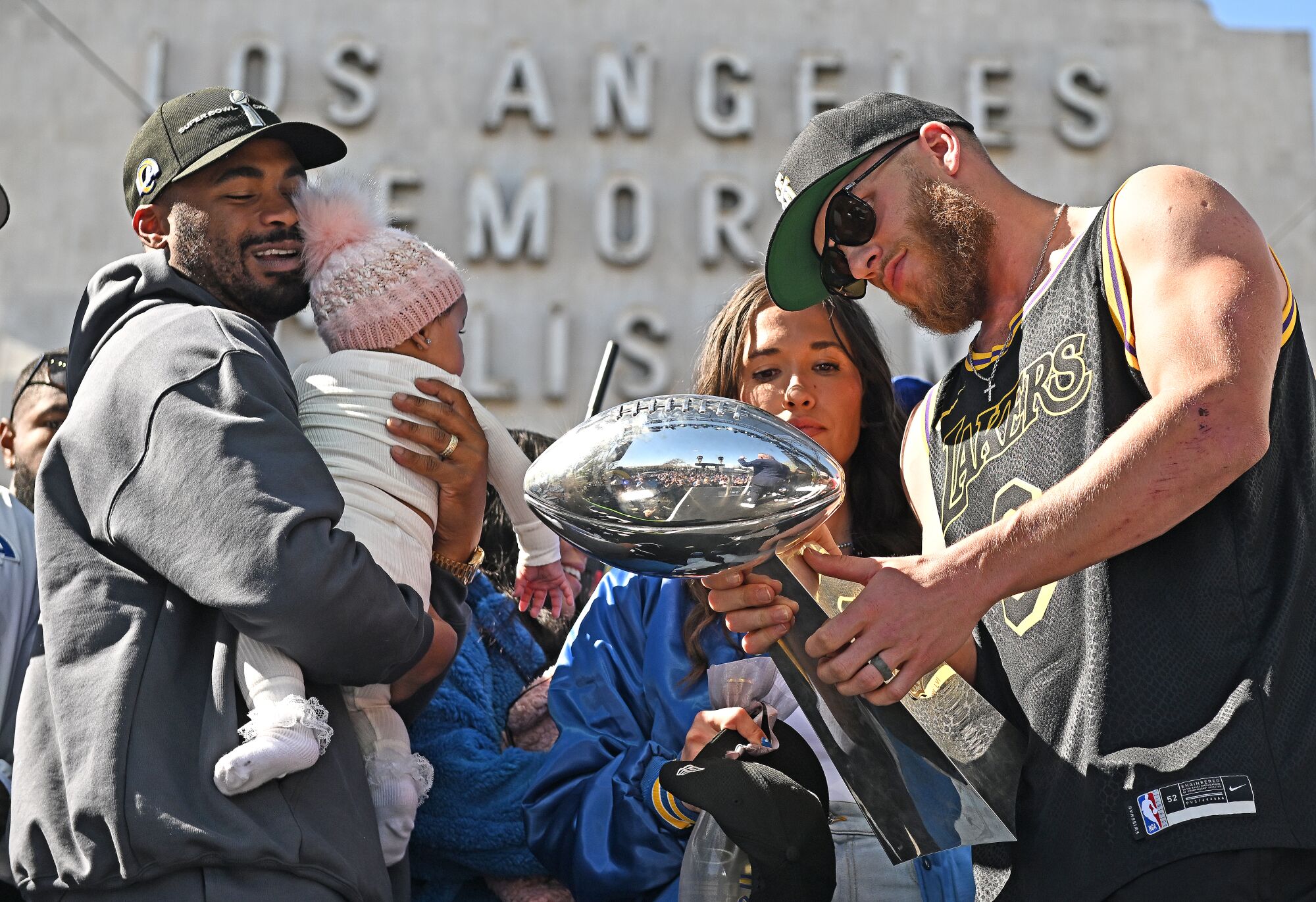 Rams receivers Cooper Kupp, right, and Robert Woods gather with the trophy during the Super Bowl celebration in Los Angeles.
