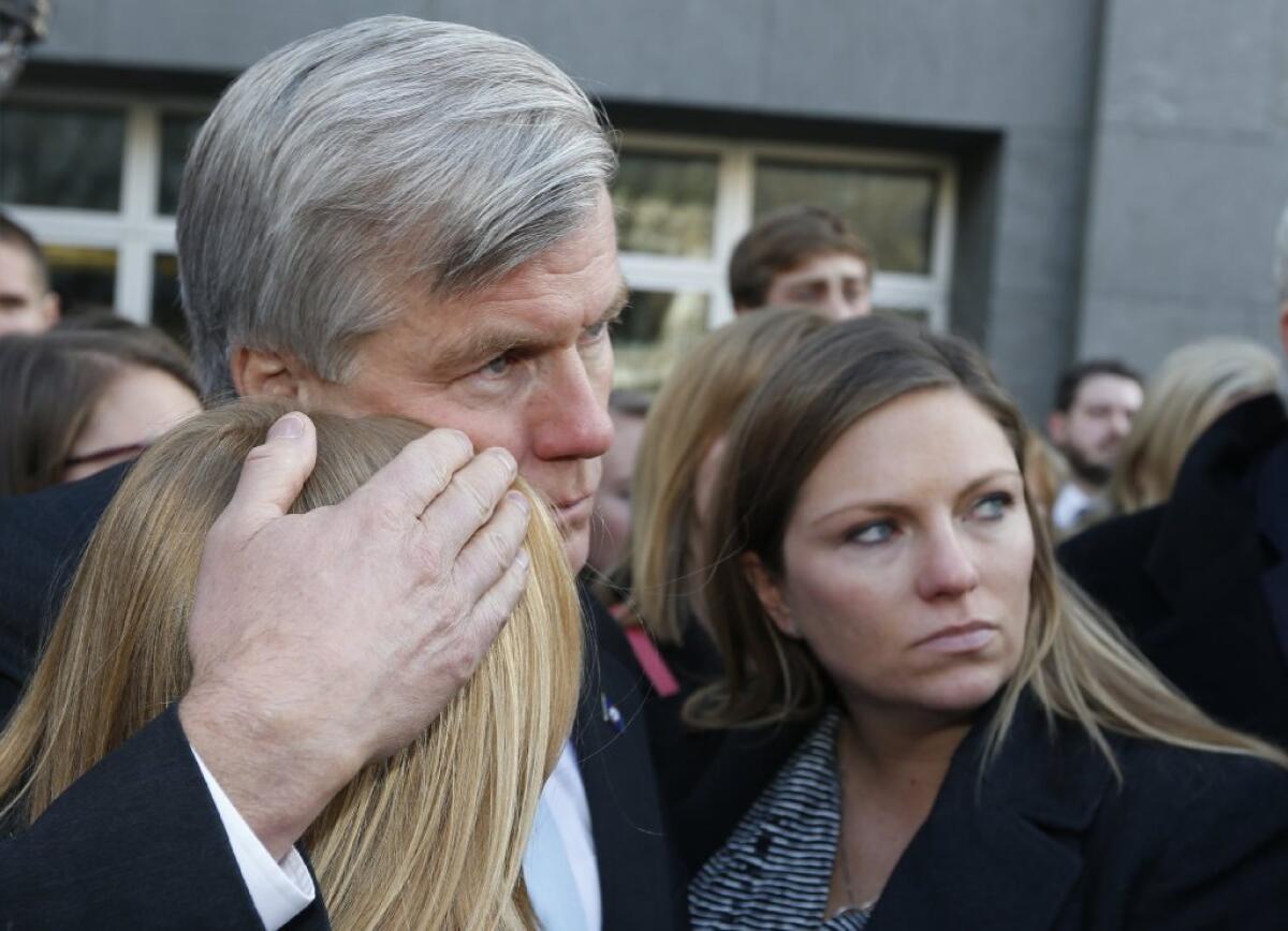 Former Virginia Gov. Bob McDonnell hugs two of his daughters outside federal court in Richmond, Va.