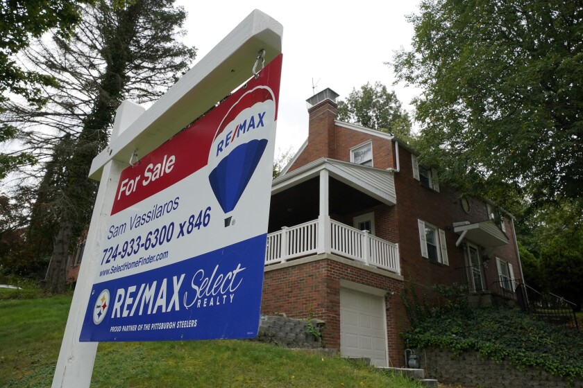 A for sale sign is displayed outside a home in Mount Lebanon, Pa., on Tuesday, Sept. 21, 2021. Average long-term U.S. mortgage rates continued to rise this past week, Thursday, Jan. 20, 2022. The rate on the benchmark 30-year loan breached 3.5%. (AP Photo/Gene J. Puskar)