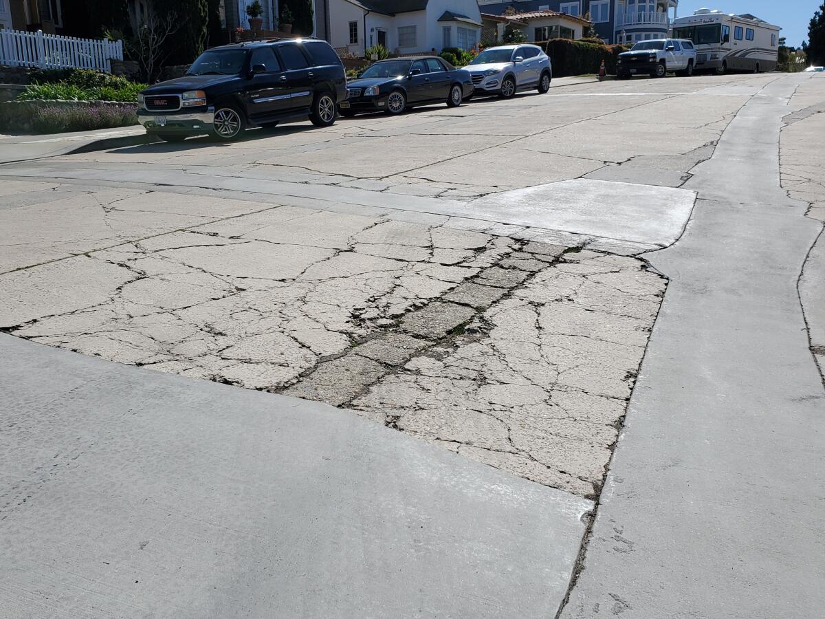 Park Row, a few blocks east of La Jolla Cove, has cracks and uneven surfaces.