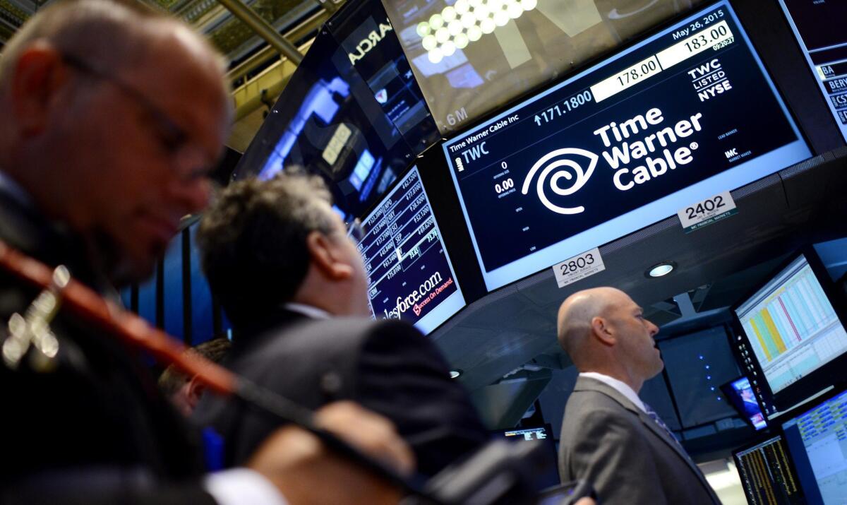 A view of a sign over the trading post handling the stock of Time Warner Cable at the New York Stock Exchange in New York on May 2015.