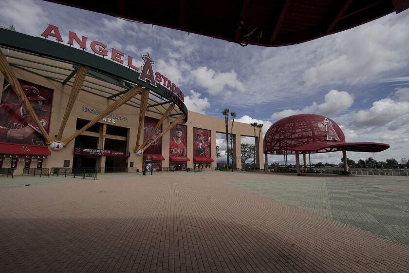 An empty Angel Stadium of Anaheim is shown in Anaheim, Calif., Wednesday, March 25, 2020. There will be empty ballparks on what was supposed to be Major League Baseball's opening day, with the start of the Major League Baseball regular season indefinitely on hold because of the coronavirus pandemic.. (AP Photo/Chris Carlson)