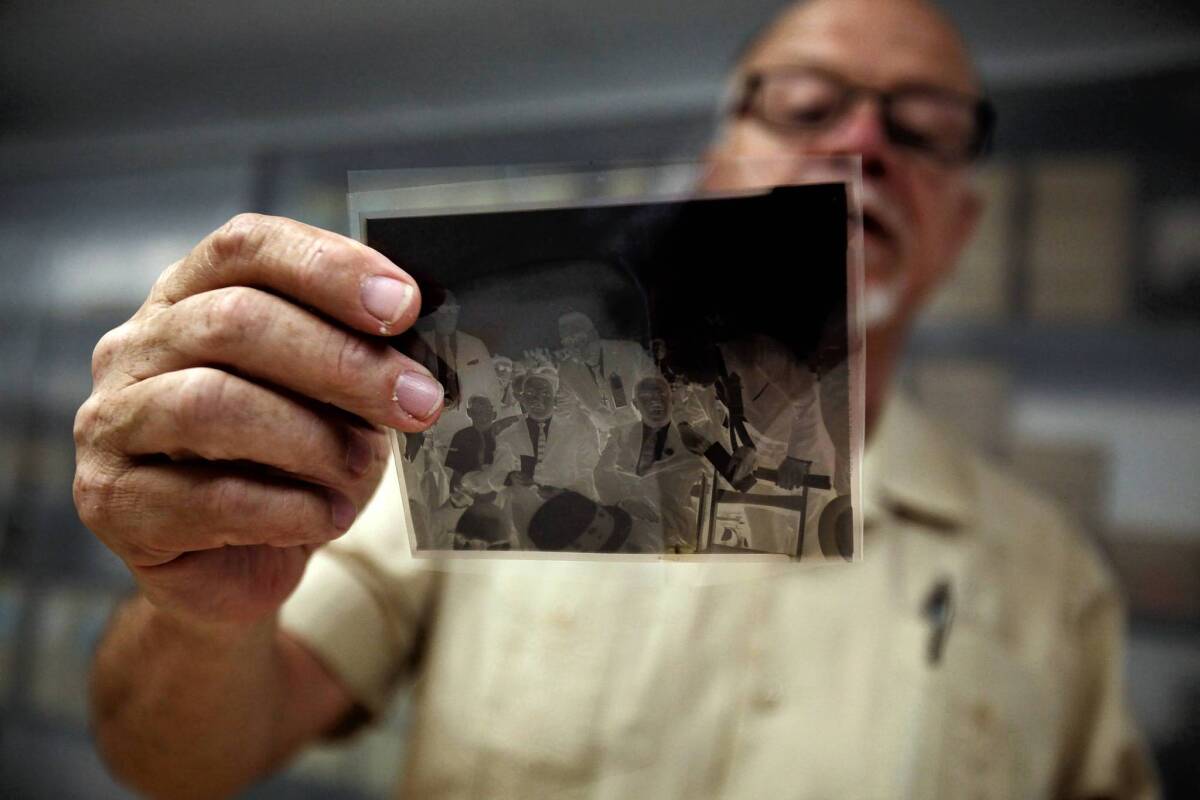 Journalism professor R. Kent Kirkton, director of the Institute for Arts & Media at Cal State Northridge, inspects a negative shot by photographer Harry Adams showing the Rev. Martin Luther King Jr., Ralph Abernathy and other civil rights leaders at a large rally in Los Angeles in 1963. "The subjects and events are such an important part of local history but are not so well known outside of the black community," Kirkton said.